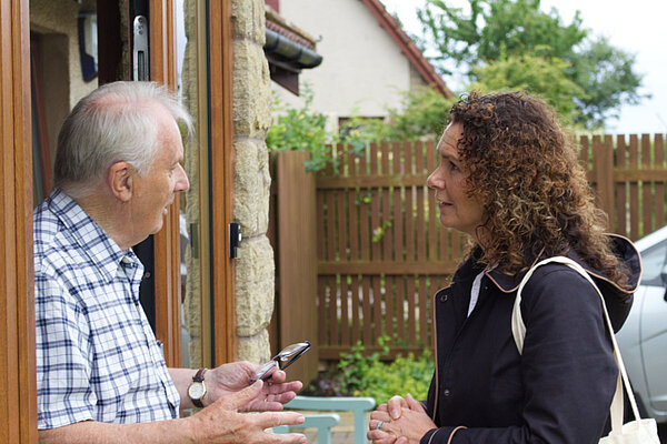 Wendy Chamberlain MP holding a conversation with a voter